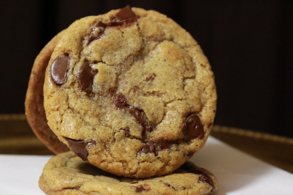 Photo of chocolate chip cookie propped up on another coookie