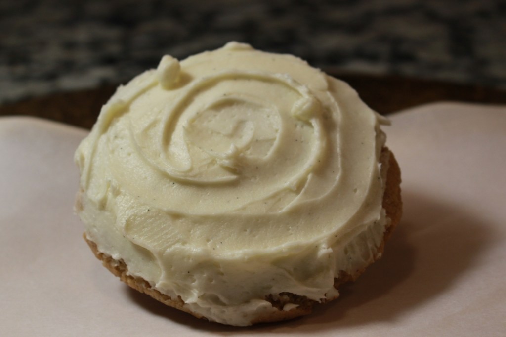 Photo of single sugar cookie with vanilla buttercream frosting